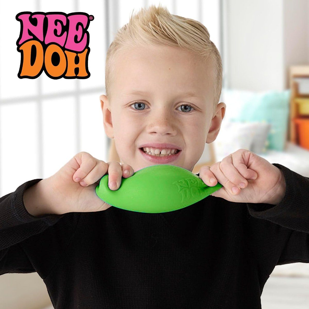 Kid stretching a NeeDoh glob across a big smile